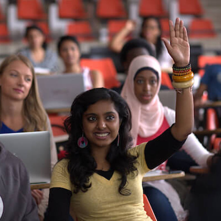 Female student raising her hand in class