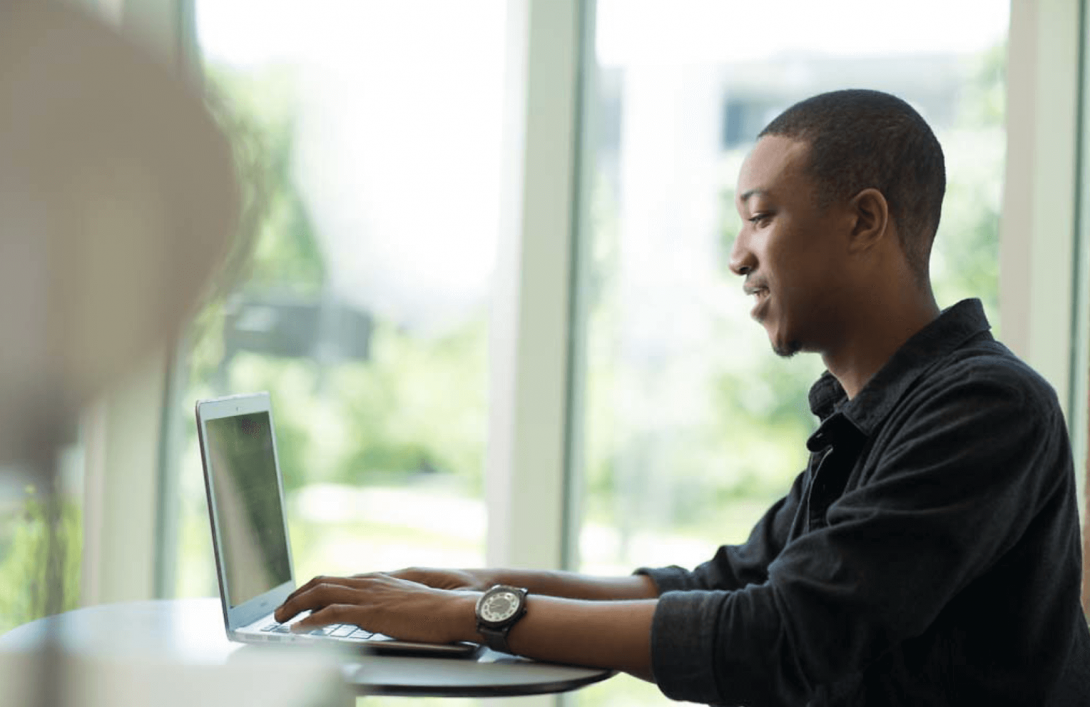 male student working on laptop