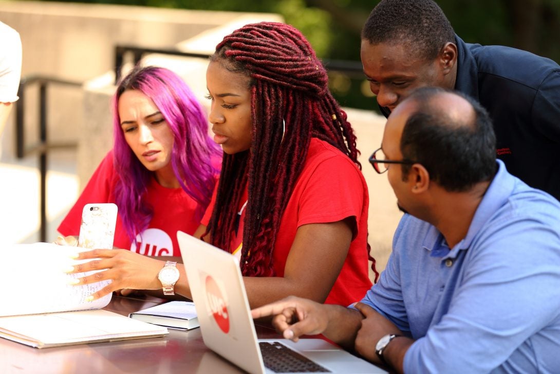 Instructor tutoring two students