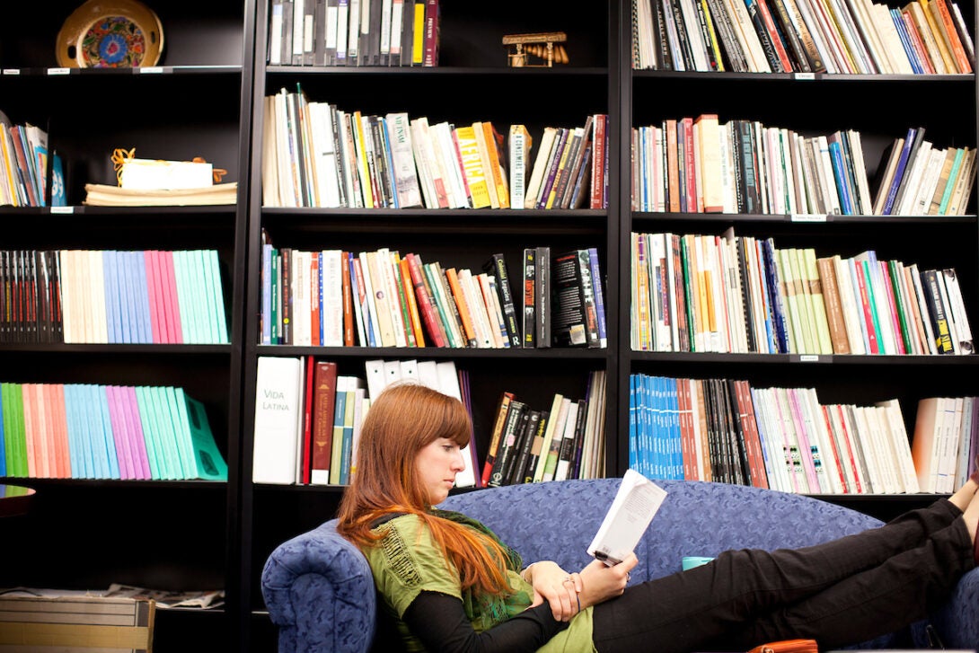 female student reading in bookstore