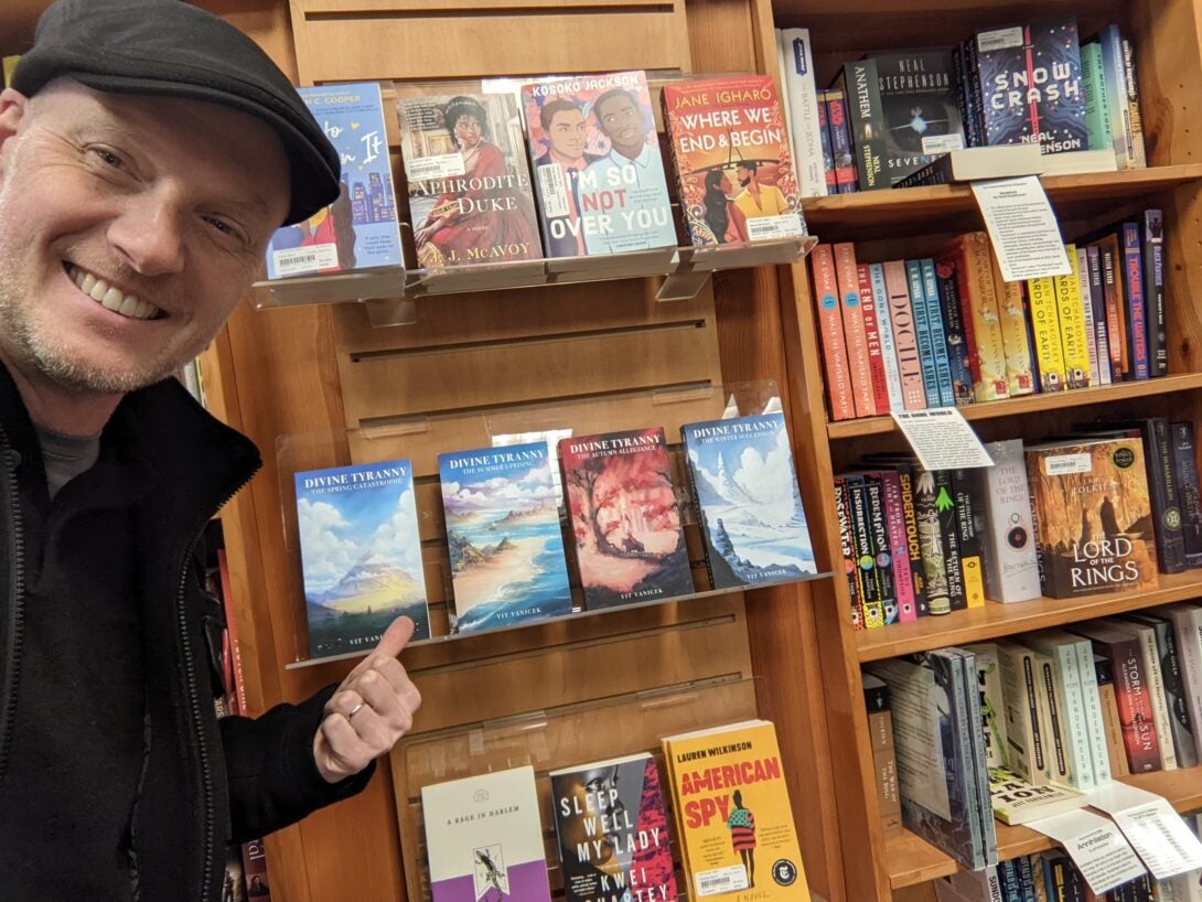 vit pointing at his books in a local bookstore