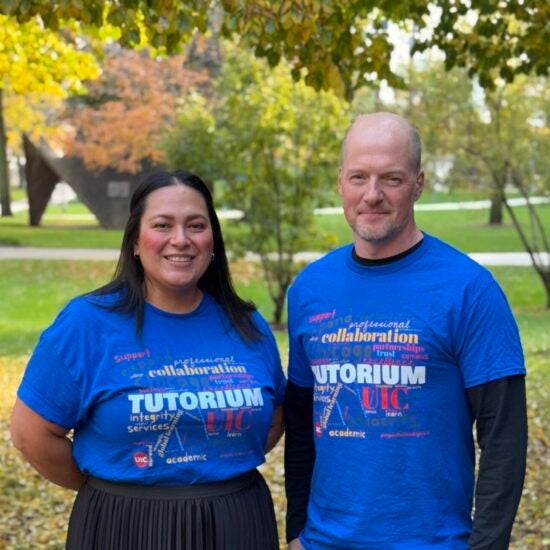 Advisors Beata and Vit holding a white sign with the red Tutorium logo